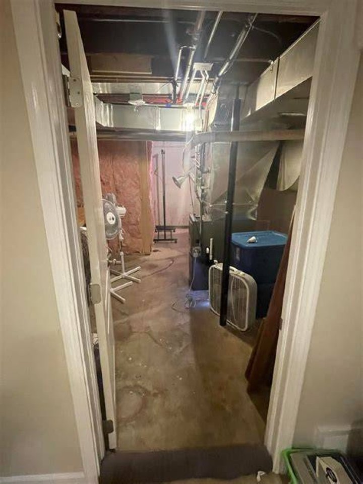 Closed off: In the basement, there is a billiard room that is separated from the main level with a deep orange barn door